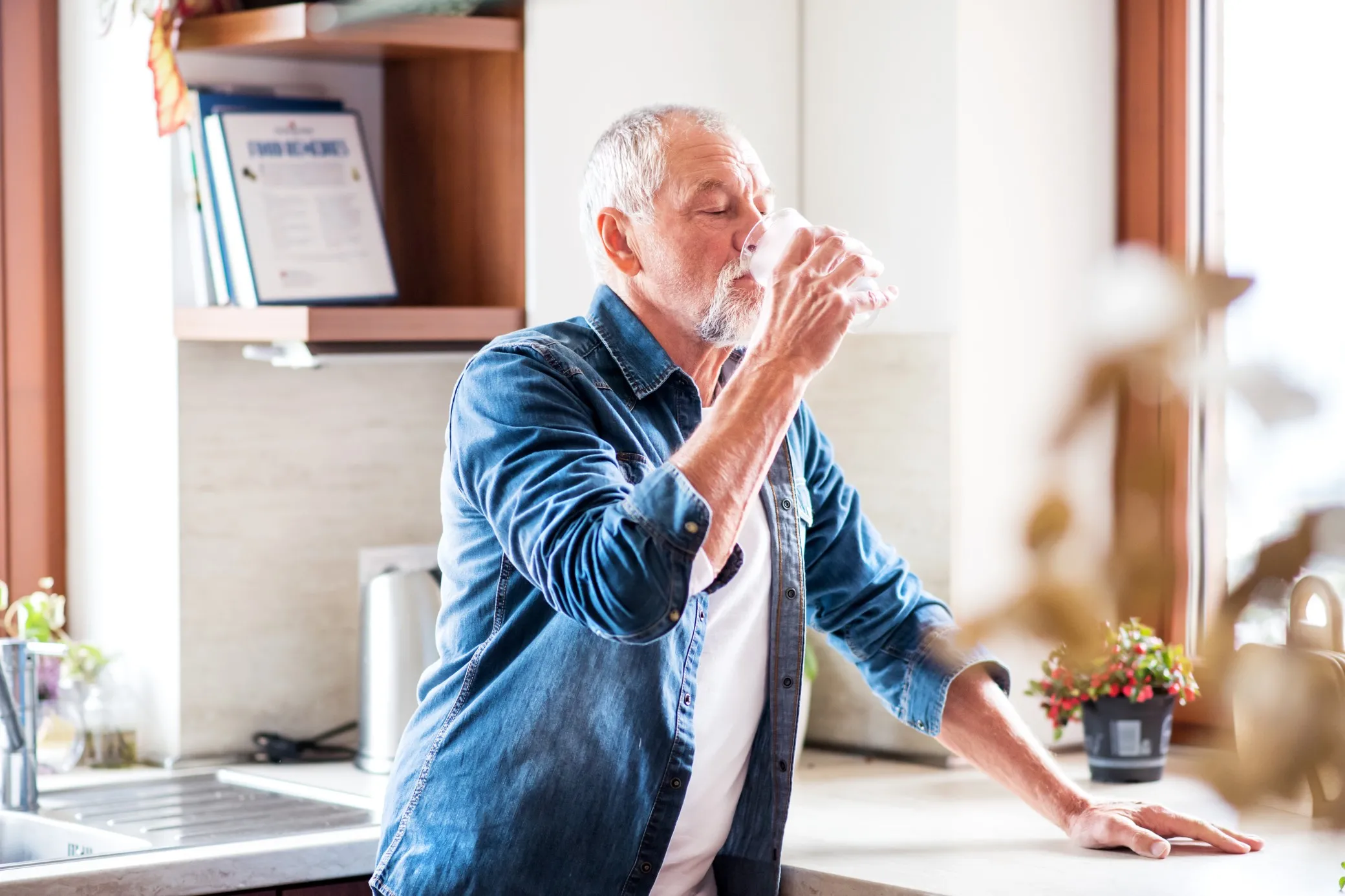 Senior man sitting drinking tea.