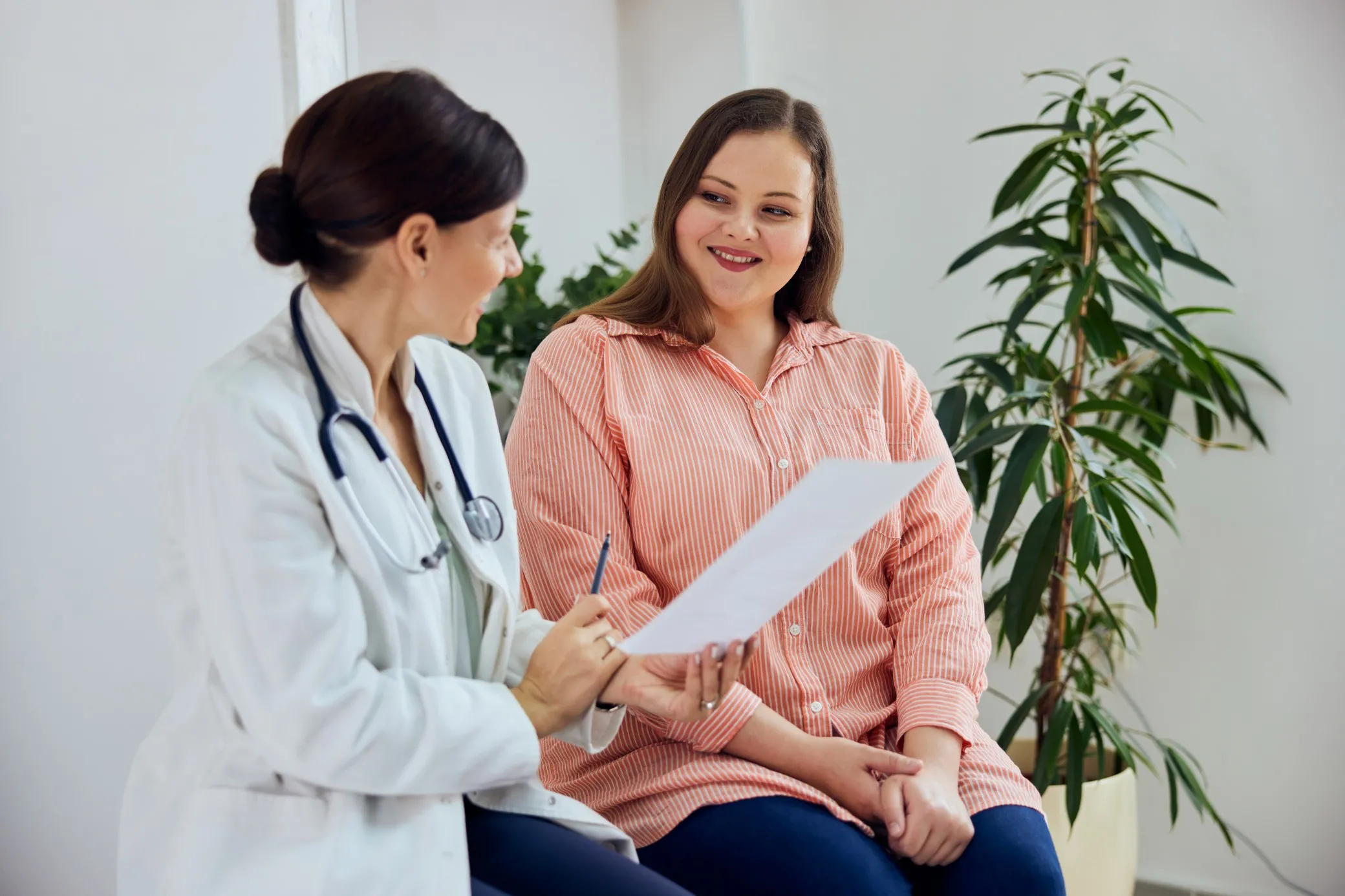 Doctor consulting with a woman in a medical office.