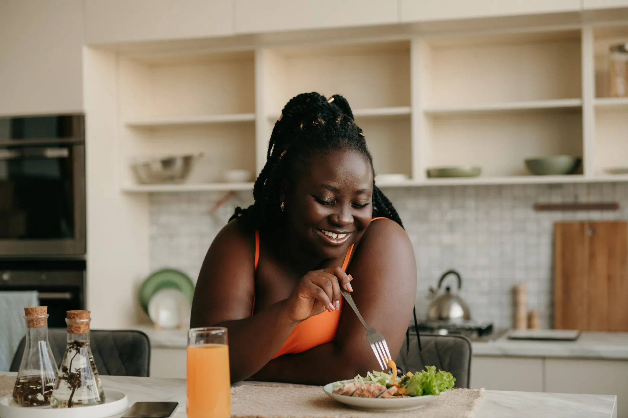 Woman cooking in a kitchen, slicing vegetables.